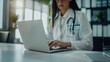 © Sabana - Female Doctor Typing on Laptop in Office