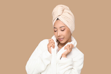 Wall Mural - Young Asian woman after shower on brown background