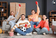 © Pixel-Shot - Group of young friends with beer watching football at home