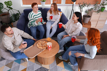 Canvas Print - Group of young friends with beer and snacks resting at home