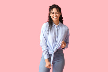 Poster - Happy young African-American woman in stylish blue collar shirt on pink background