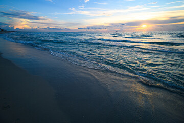 Ocean waves background. Sunrise on the sea with clouds background. Seascape at evening.