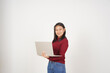 © Sino Images Studio - Young Asian woman working on laptop wearing red t-shirt isolated on white background