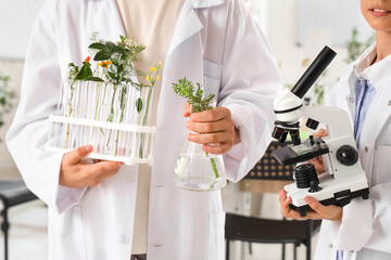 Sticker - Pupils with microscope and plants in Biology class, closeup