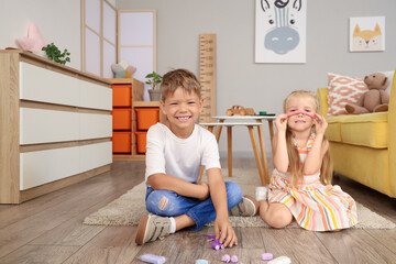 Canvas Print - Cute little children sculpting from plasticine on floor at home