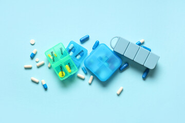 Wall Mural - Plastic containers with pills on blue background. Top view