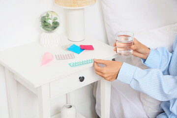 Poster - Young woman with condoms in bedroom