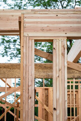 closeup detail of new house construction, wall wood framing started and glue laminate header beam in
