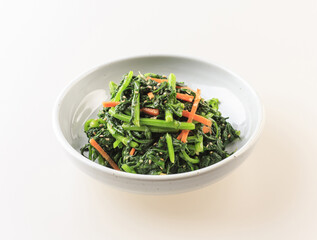 Poster - Close-up of seasoned crown daisy with carrots and sesame seeds on a dish, South Korea
