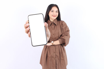 Smiling beautiful young Asian woman wearing casual brown showing a screen mobile phone for an advertisement and presenting isolated over white background. People Lifestyle Concept