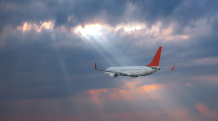 Wall Mural - Airplane flying over tropical sea at sunset