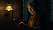 © alexkich - Old lady with the glasses looking at her mobile phone with dark background