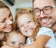 © peopleimages.com - Happy, family and and portrait in lounge parents and bonding with hug for daughter, girls and fun. Home, kids and mom in living room, woman and man with child, smile and embrace for care and love