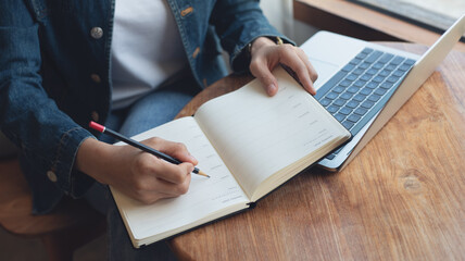 Wall Mural - 2025 Event planner timetable agenda plan on schedule event. Business woman checking weekly planner, taking note on calendar notebook on office table. Calendar event plan, work planning