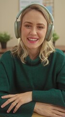 Canvas Print - Smiling caucasian woman with headphones in a home setting.