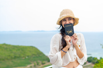 Happy Caucasian woman relax and enjoy outdoor lifestyle travel nature ocean tropical island on summer beach holiday vacation. Attractive girl traveler showing passport at mountain peak in sunny day.