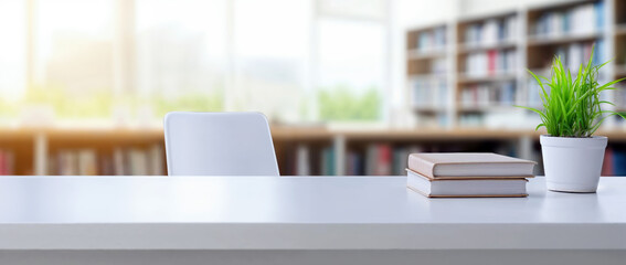 Aufkleber - White desk with books and a plant blurred library background