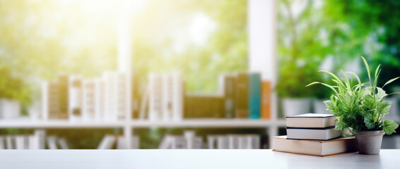 Aufkleber - Stack of books on a desk with a green plant, and blurred bookshelf and sunlight from window background
