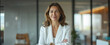 © Oleksandr - Confident smiling middle aged business woman attorney, 45 years old lady entrepreneur, mature female professional executive manager leader standing arms crossed in office looking at camera