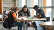 © Felippe Lopes - Three students study together in a library, focused on their books.