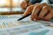 © ChomStyle - Close-up of hands analyzing financial data on paper with graphs and charts, highlighting business performance and market trends.