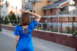 © Natalia - Close-up portrait of a woman against the background of a modern city, back view, copy space