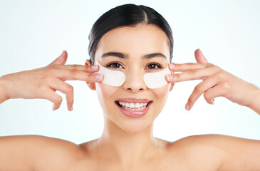 Canvas Print - Portrait, happy woman and eye patch in studio for skincare, beauty and smile for wellness. Model girl, confidence and hands for transformation, collagen and glow for facial in spa by white background