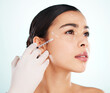 © peopleimages.com - Beauty, woman and face injection for plastic surgery, treatment and dermatology. Facial, skincare or surgeon with syringe for medical cosmetics, collagen filler or toxin isolated on studio background