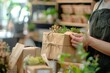 © Ahmed - Eco vendor go green packaging parcel carton box in net zero waste store asian seller retail shop. Earth care day small SME owner asia people wrap reuse brown paper pack gift reduce plastic free order