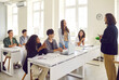 © Studio Romantic - Young girl student standing at the desk in classroom and answering the male teacher with a college or high school students applauding her during a lesson. Education and learning concept.