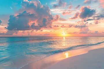 Wall Mural - Sunset at the ocean at a tropical sand beach with beautiful blue water. Summer island landscape.