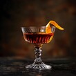 © NatthaphonSiri - Close-up of a Cocktail with an Orange Peel Garnish.