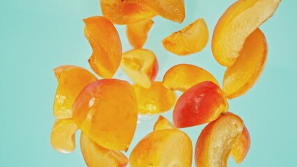 Aufkleber - Super Slow Motion of Falling Apricots Slices into Water, Blue Background. Filmed on High Speed Cinema Camera, 1000 fps. Camera Tracking the Target.