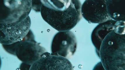 Poster - Super Slow Motion of Falling Blueberries Into Water on Blue Background. Filmed on High Speed Cinema Camera, 1000 fps.