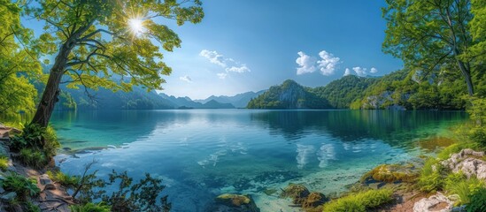 Sticker - Serene Mountain Lake With Sunlight Filtering Through Foliage