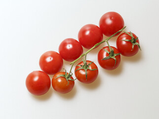 Sticker - Close-up and top angle view of fresh cherry tomatoes with stem in a row on white floor, South Korea
