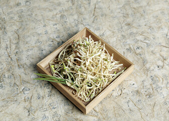 Sticker - Seoul, South Korea - February 9, 2014: Close-up of dried shreded radish roots on wood plate and Hanji paper
