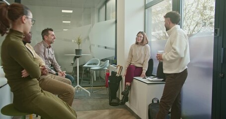 Wall Mural - Business colleagues gather in a modern office for a casual meeting. They discuss data and growth, engaging in group conversation and collaboration.