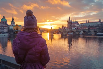 Wall Mural - Female traveler in purple coat by Vltava river  Prague.