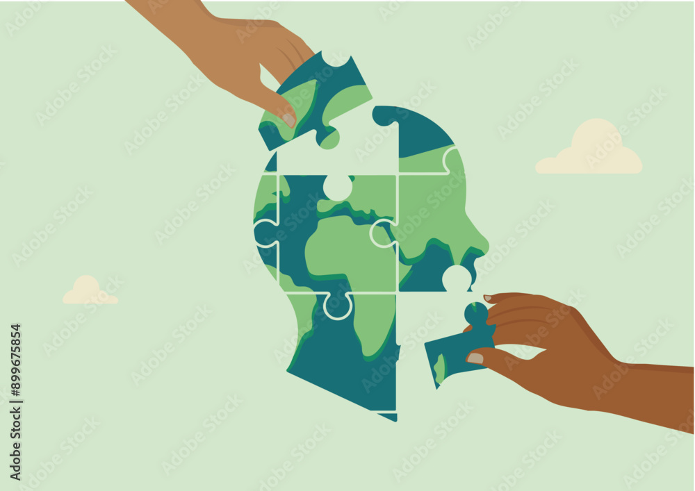 Two hands connecting puzzle pieces to form a world map within a human ...