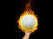© pornchai - Soccer ball in hand with burning flames.