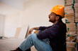 © Drazen - Exhausted construction worker resting on the floor.