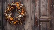 © fivan - A beautiful autumn wreath made of corn, dried flowers, and small pumpkins hanging on a rustic door