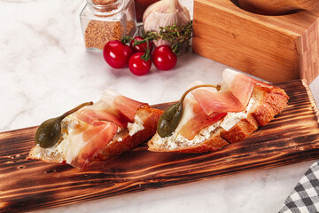 Wall Mural - Bruschetta with jamon and caper berries