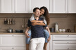 © fizkes - Beautiful just married couple spend carefree leisure in modern renovated cozy kitchen. Happy homeowners family tenants relaxing in own or rented house. Accommodation, harmonic relationships, marriage