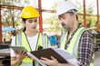 © DG PhotoStock - Engineers team talking about working plan at construction site.