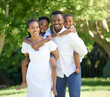 © peopleimages.com - Black family, portrait and piggyback in park with love for bonding together, affection and care outdoor. Happy people, parents or kids in nature for summer holiday, security or support in environment