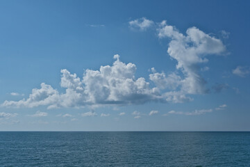 Wall Mural - Beautiful clouds in the blue sky over the sea. Nature background