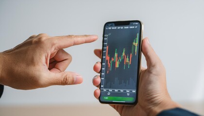 Finger pointing to smartphone for stock trading