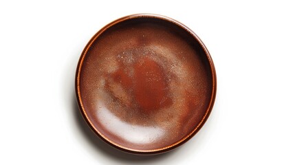 Brown plate on white background from above